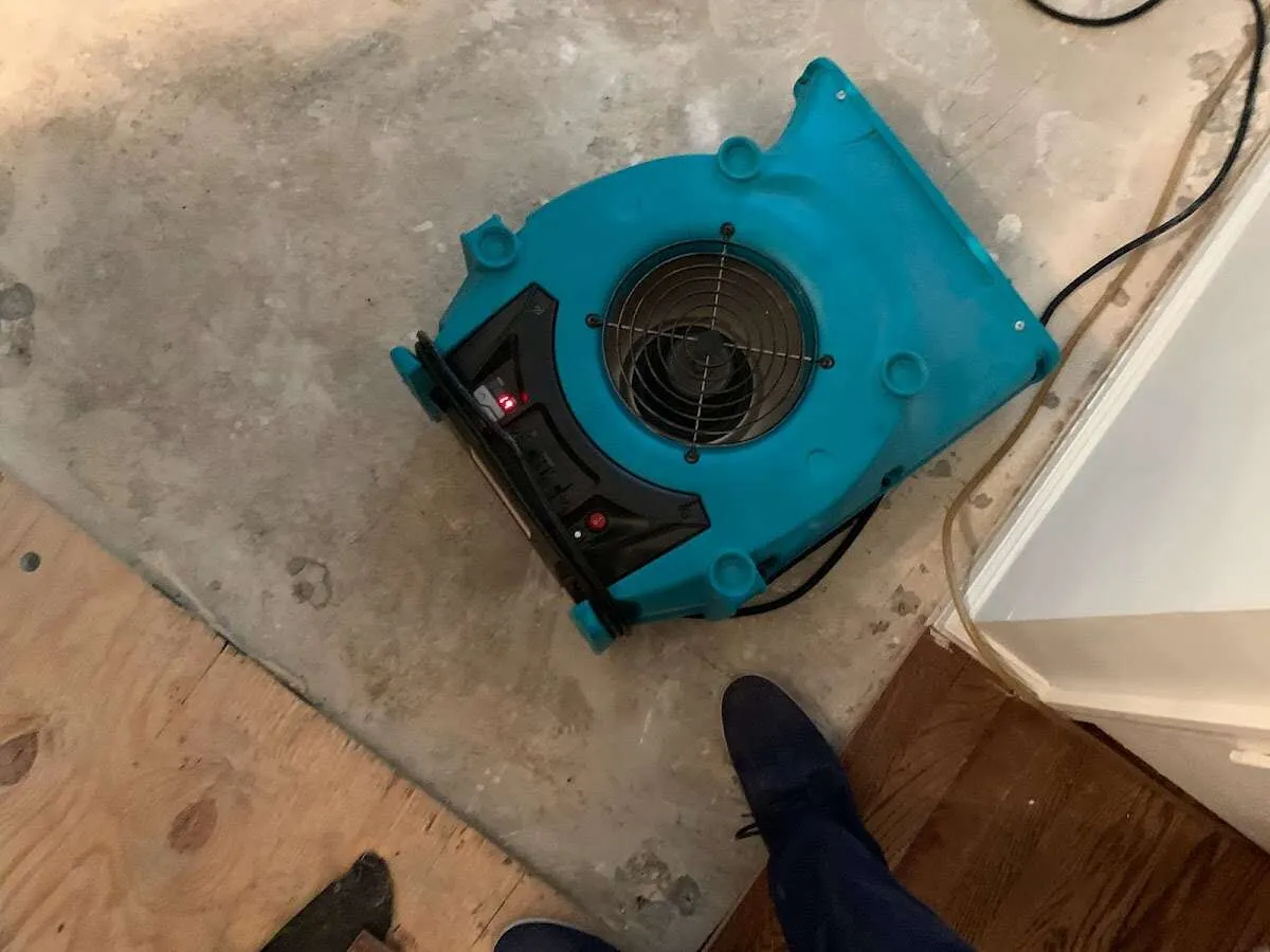 Air mover drying subfloor during Commercial Water Damage Restoration in Patton